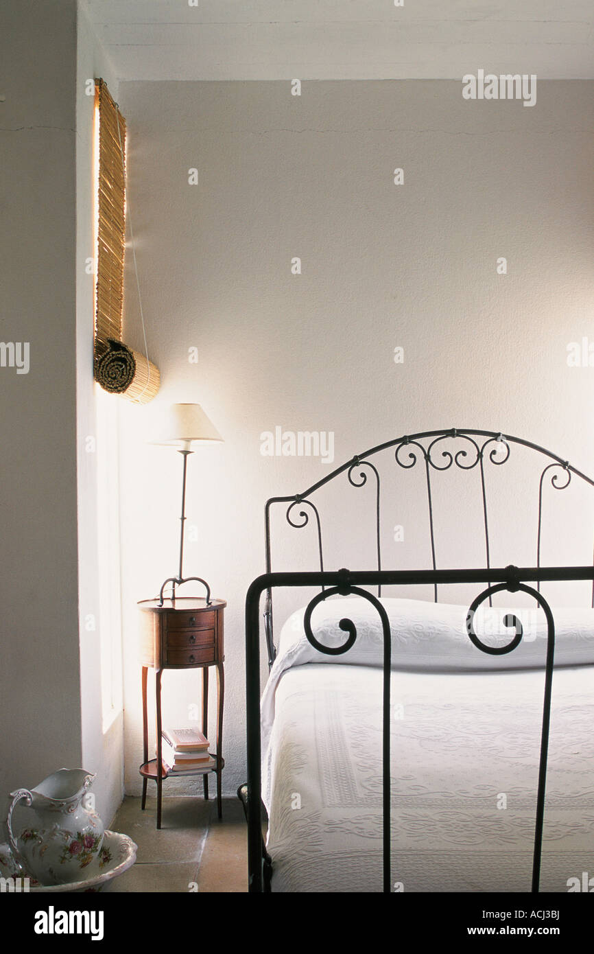 Bedroom White Coverlet Bedside Venetian Blind White Walls