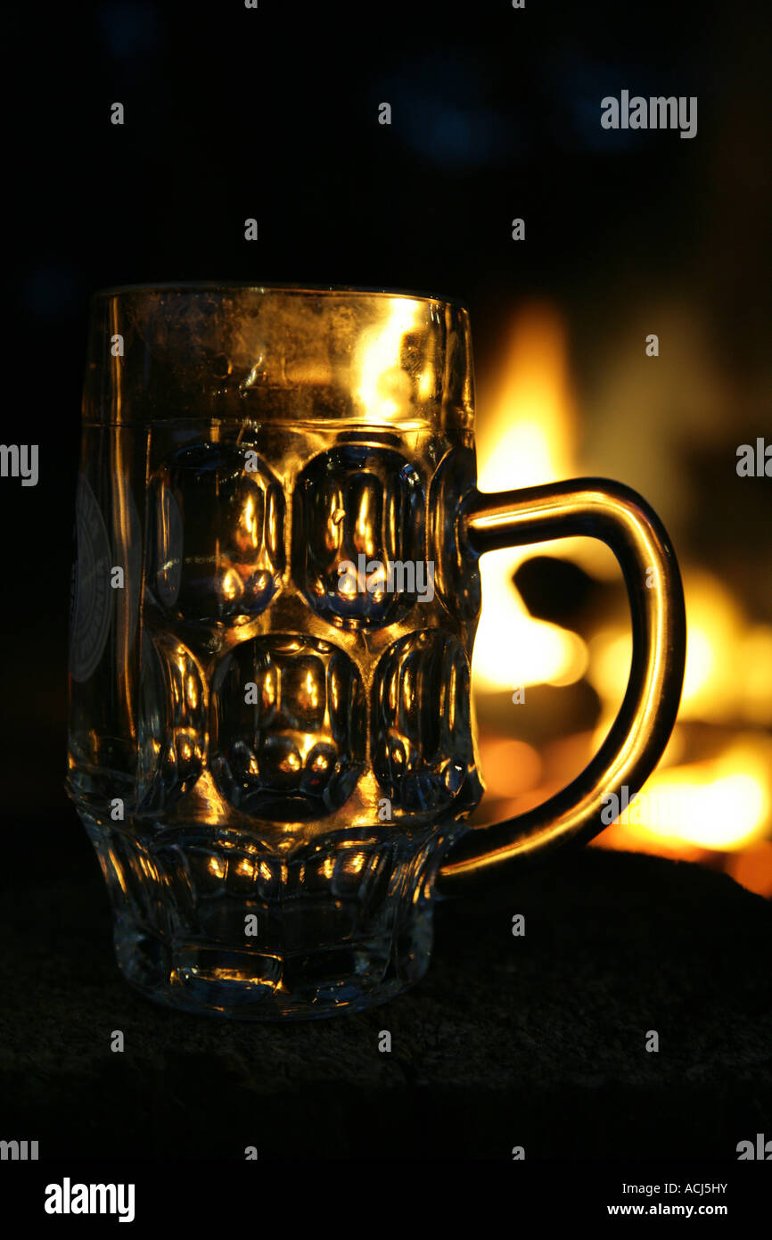 Beer jug with Campfire in background Stock Photo