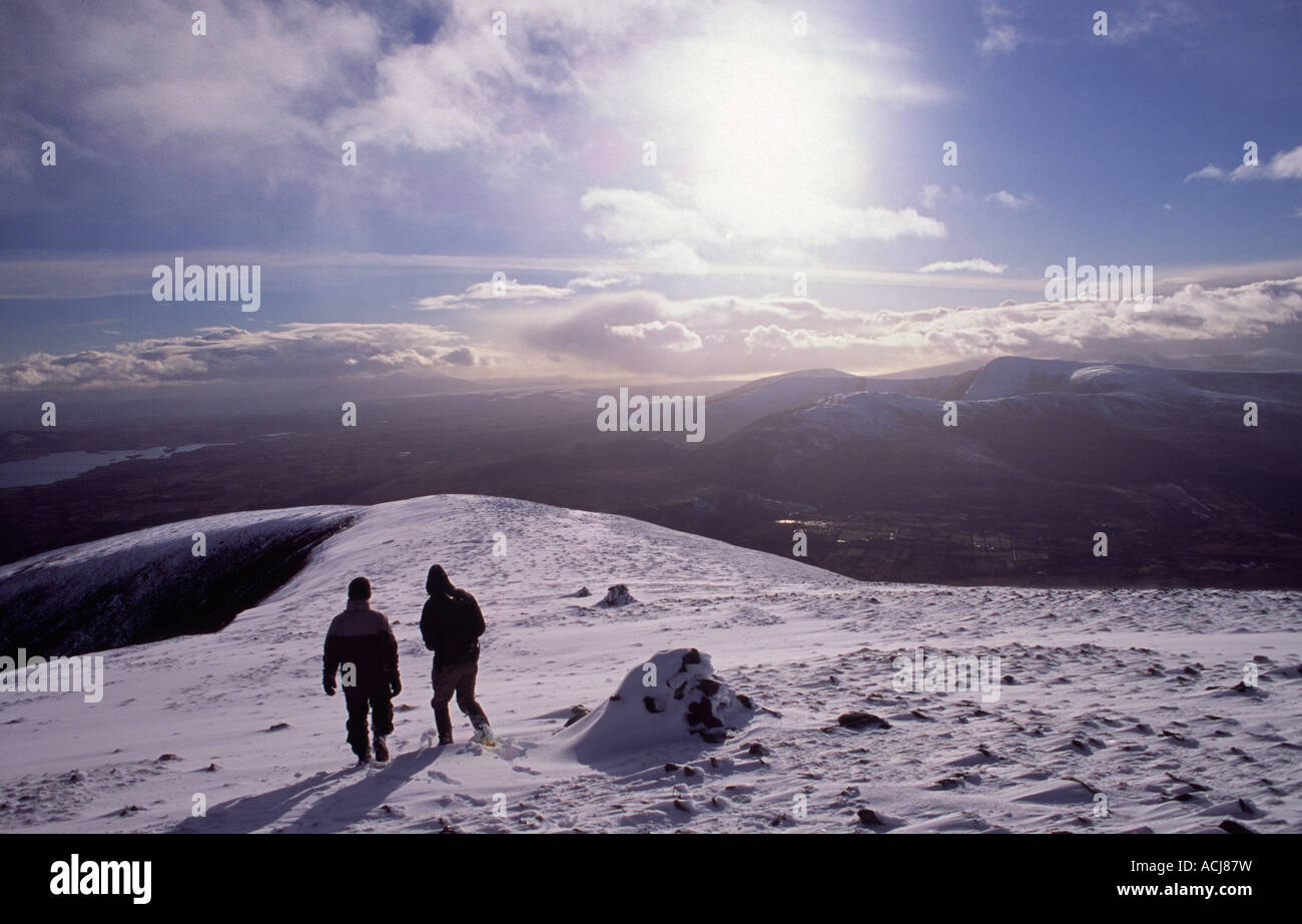 Winter walkers descending from Nephin, Nephin Beg Mountains, County Mayo, Ireland. Stock Photo
