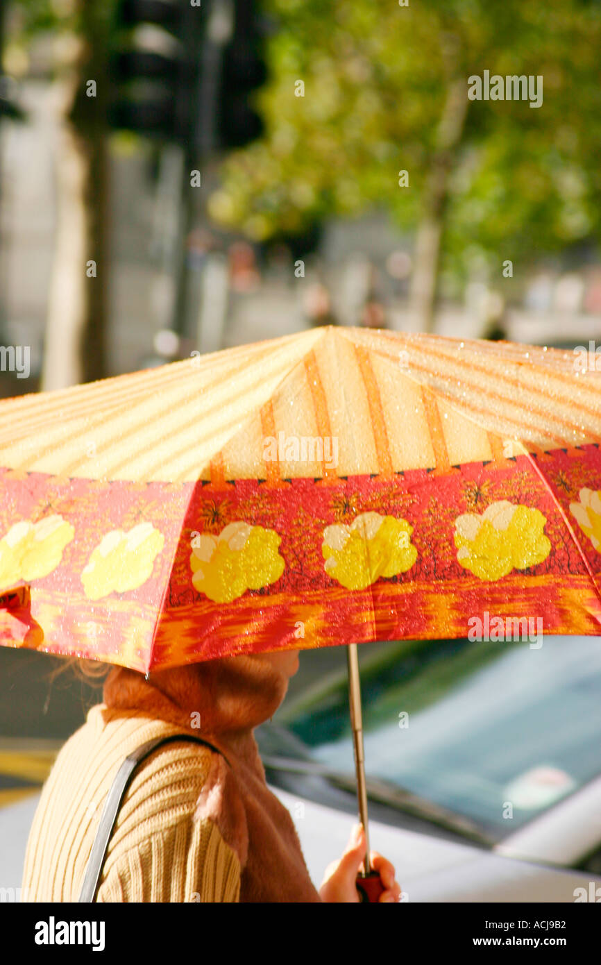Woman under umbrella in rain London England Stock Photo Alamy