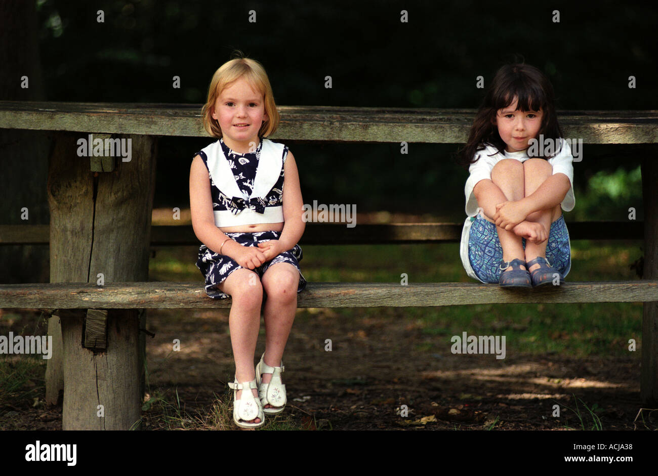 Two blonde girls sitting bench hi-res stock photography and images - Alamy