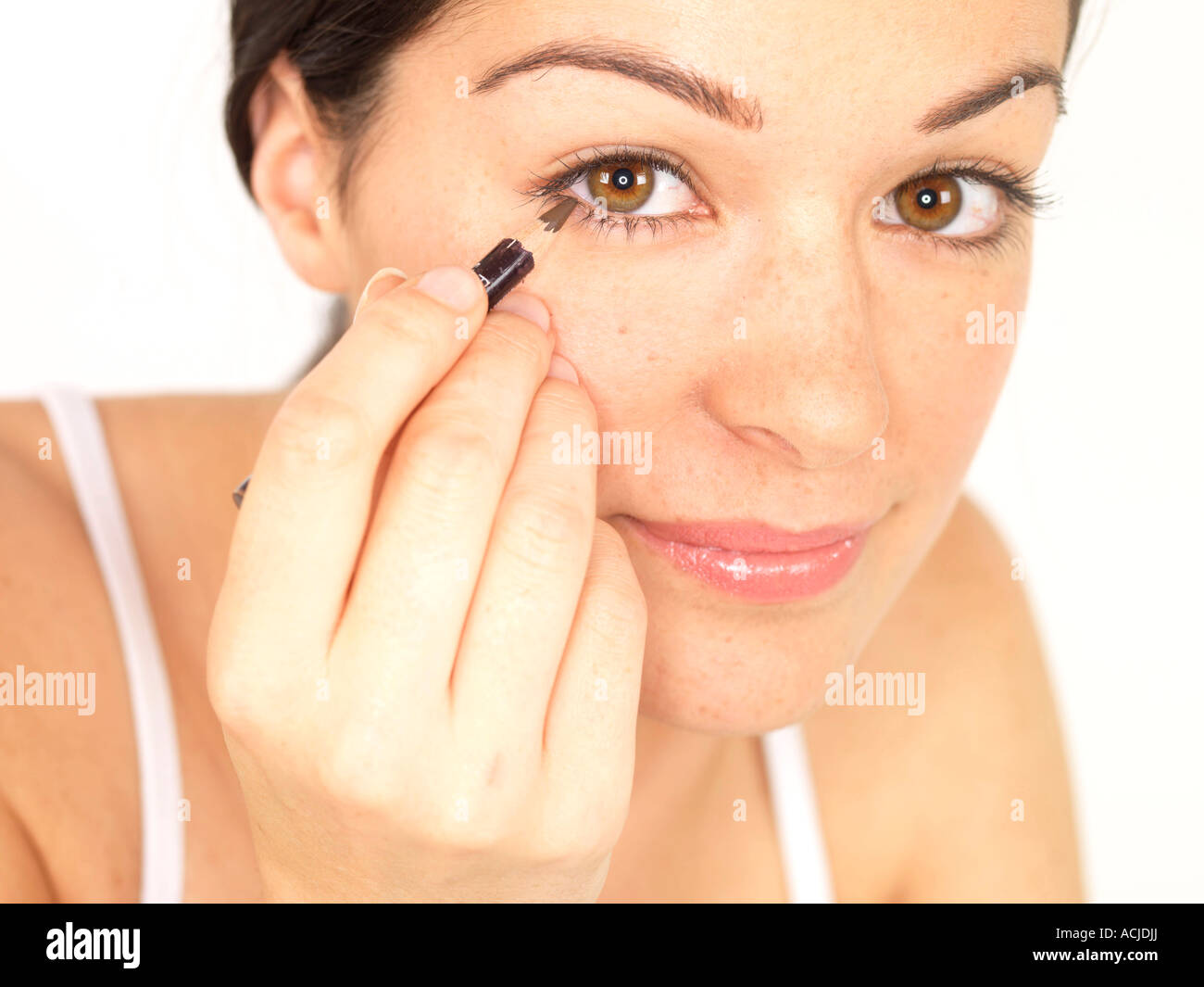 Young Woman Applying Eyeliner Model Released Stock Photo