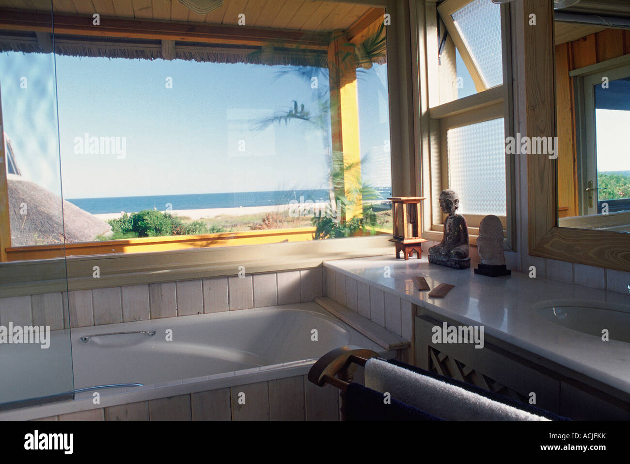 Bathroom bathtub and sink bay windows sea and blue sky Stock Photo Alamy
