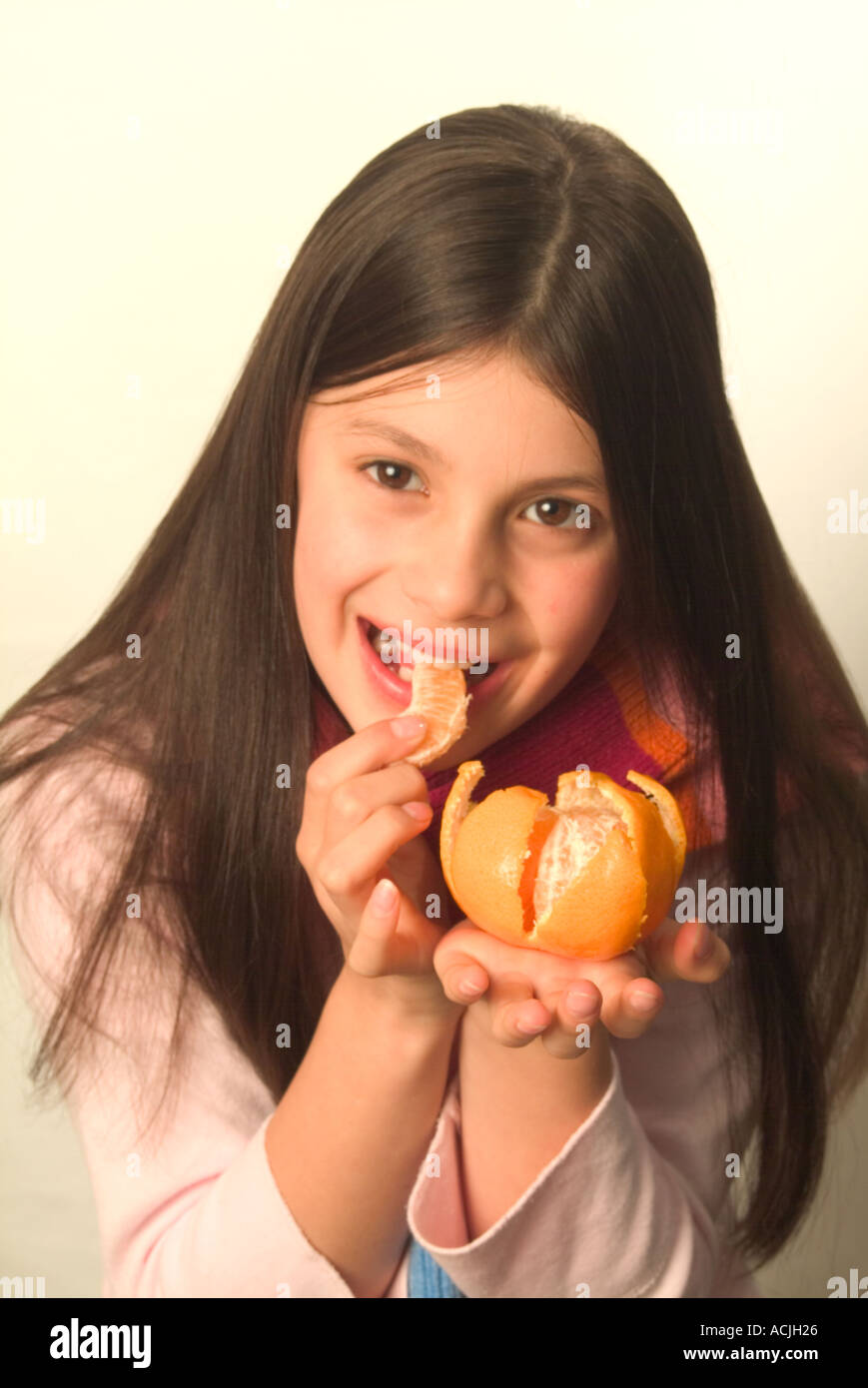 Young girl eating fruit Stock Photo Alamy