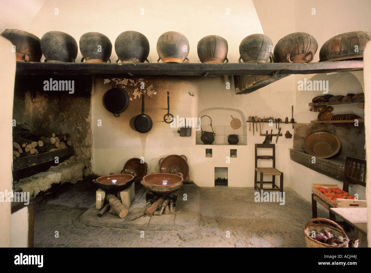 Ancient Cooking Rack Ancient kitchen chimney plate on hearth oven stone sink pots aligned ...