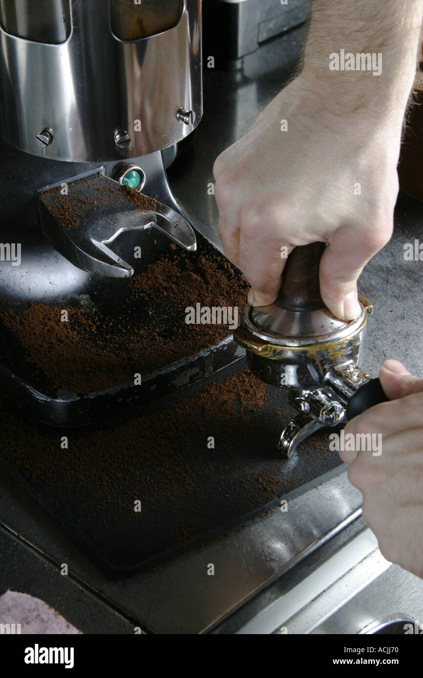 Detail image of tamping espresso grounds into a Stock Photo Alamy