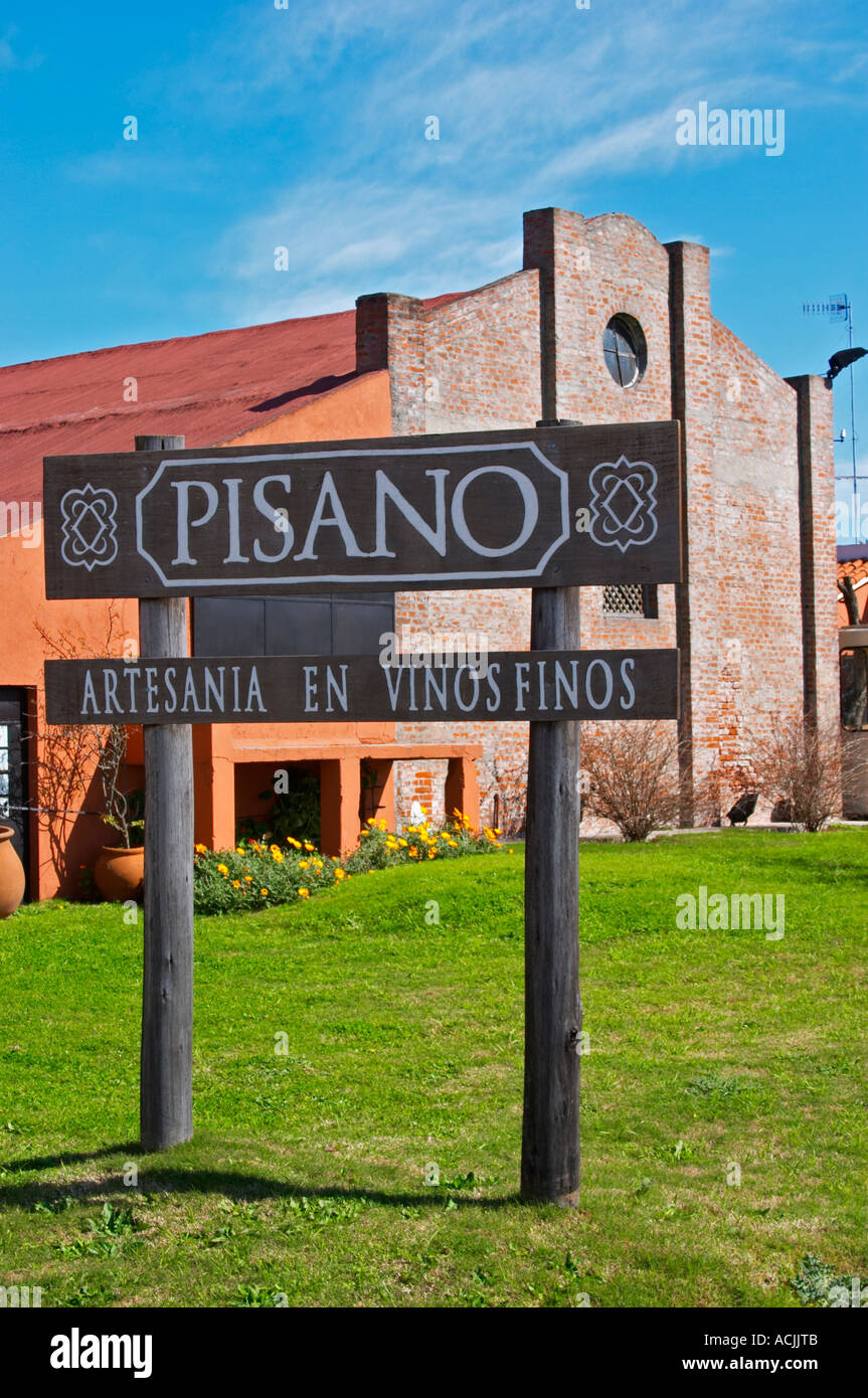 A view over the main winery building and a sign to the winery. Painted in ochre red and with a grass lawn in front. Bodega Pisano Winery, Progreso, Uruguay, South America Stock Photo