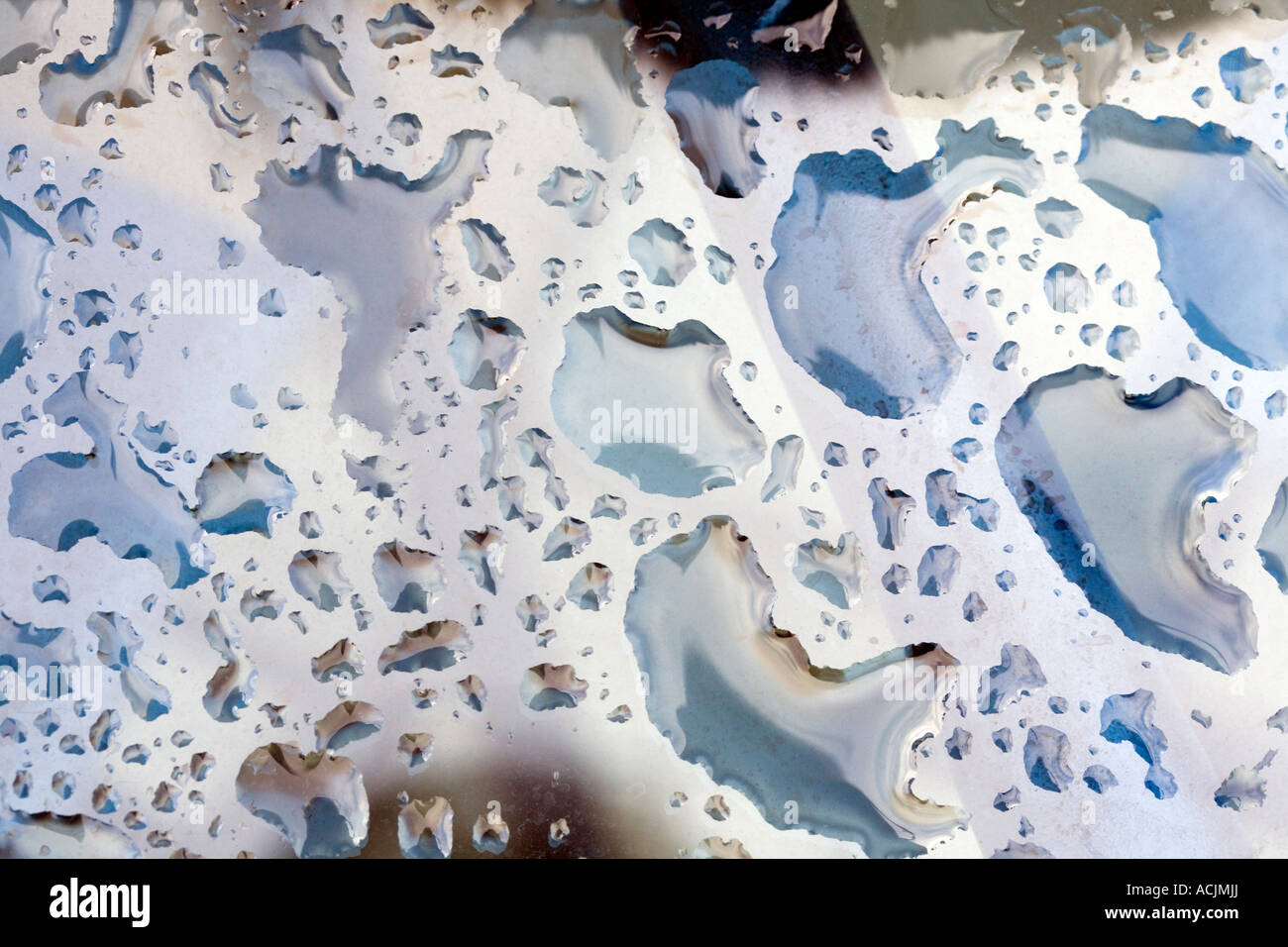 WATER ON A GLASS TOP CREATING PATTERNS Stock Photo