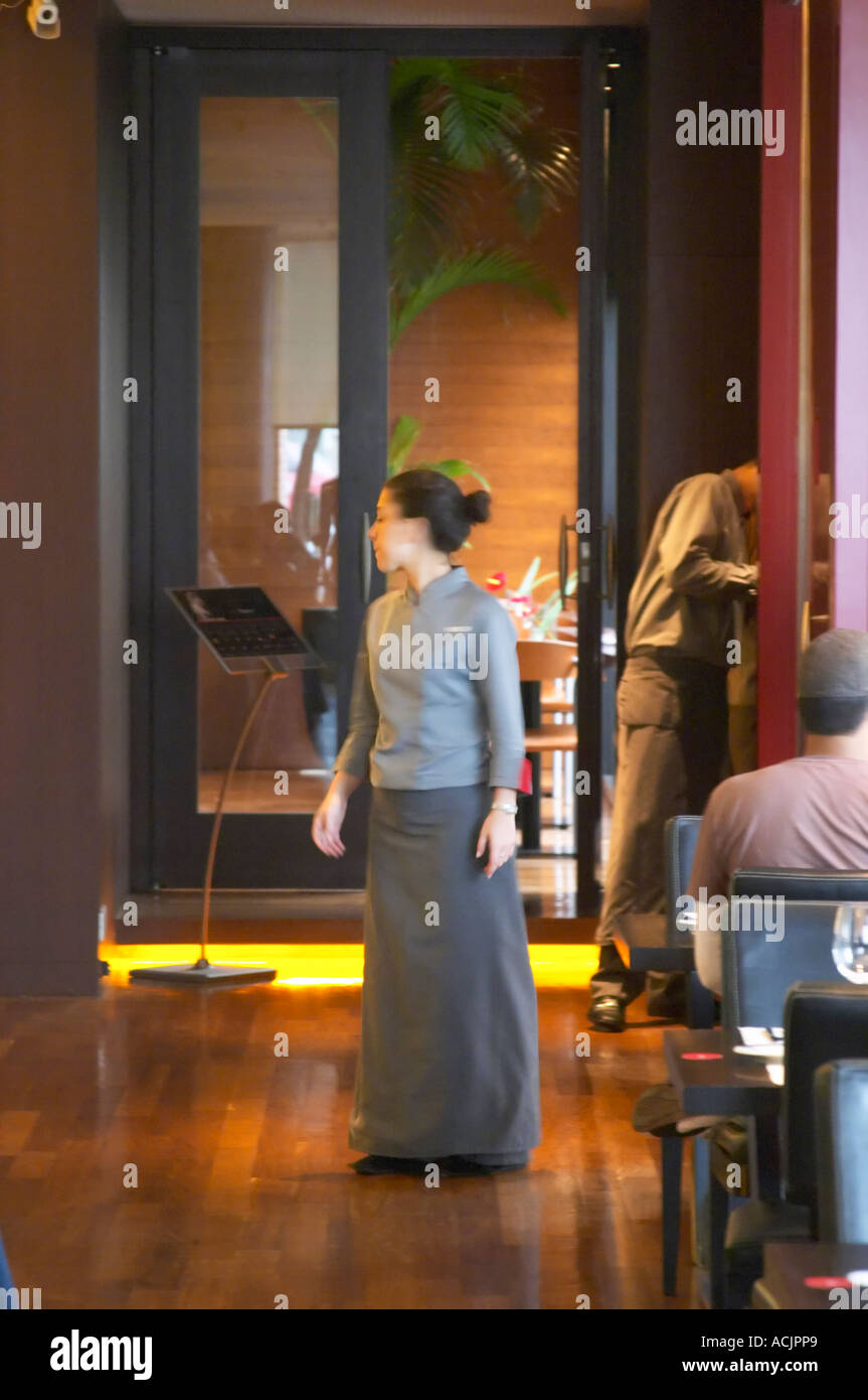 A waitress dressed in long grey skirt and gray blouse. The Restaurant Red at the Hotel Madero Sofitel in Puerto Madero, Buenos Aires Argentina, South America Stock Photo