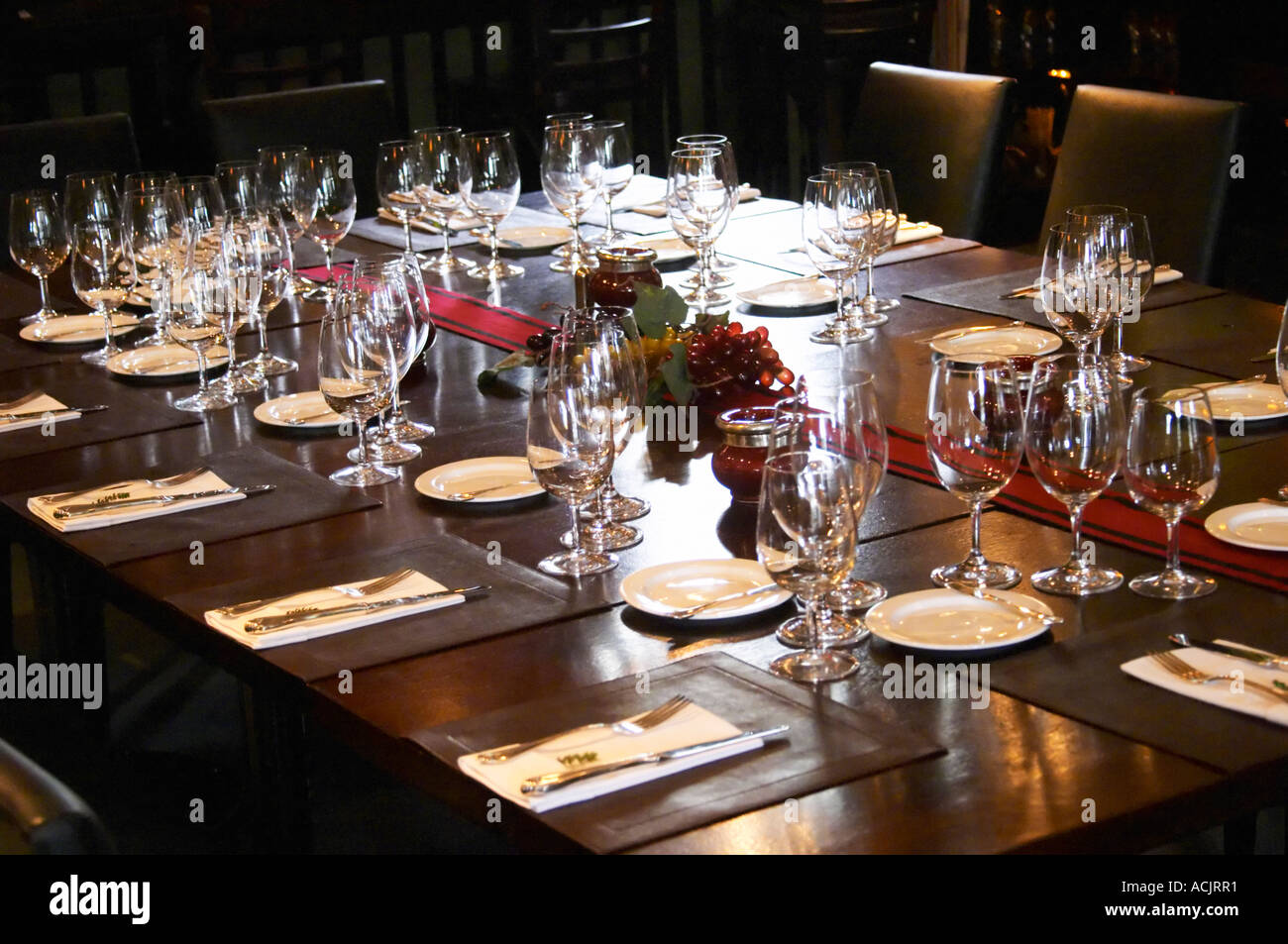 Table set for lunch guests with many wine glasses for tasting and knives and forks and other silverware. The O’Farrell Restaurant, Acassuso, Buenos Aires Argentina, South America Stock Photo