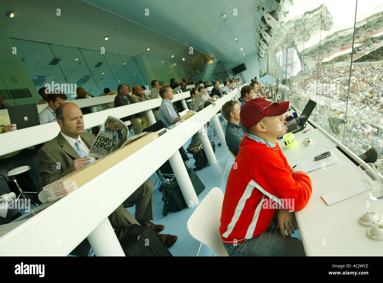 Journalists at work inside the media centre at Lords cricket ground London  Stock Photo