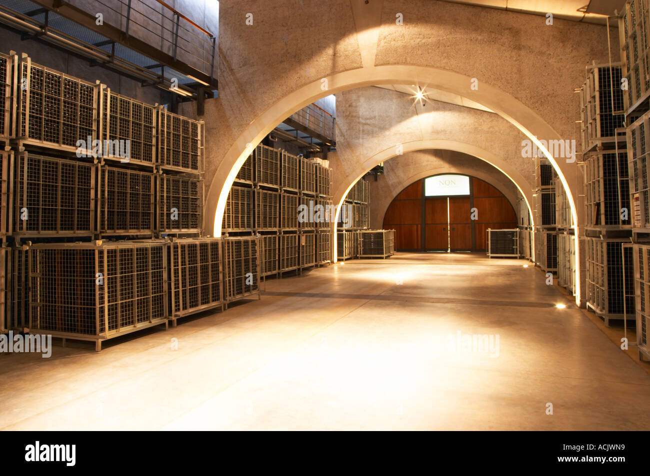 The bottle aging room with thousands of bottles in wire cages Bodega