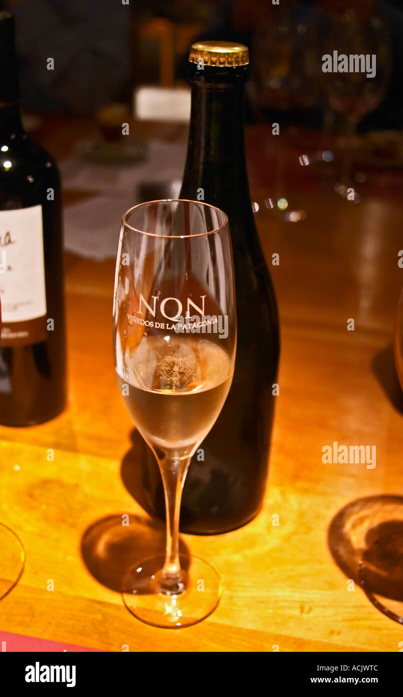 A glass flute of sparkling wine, engraved with the name of the winery