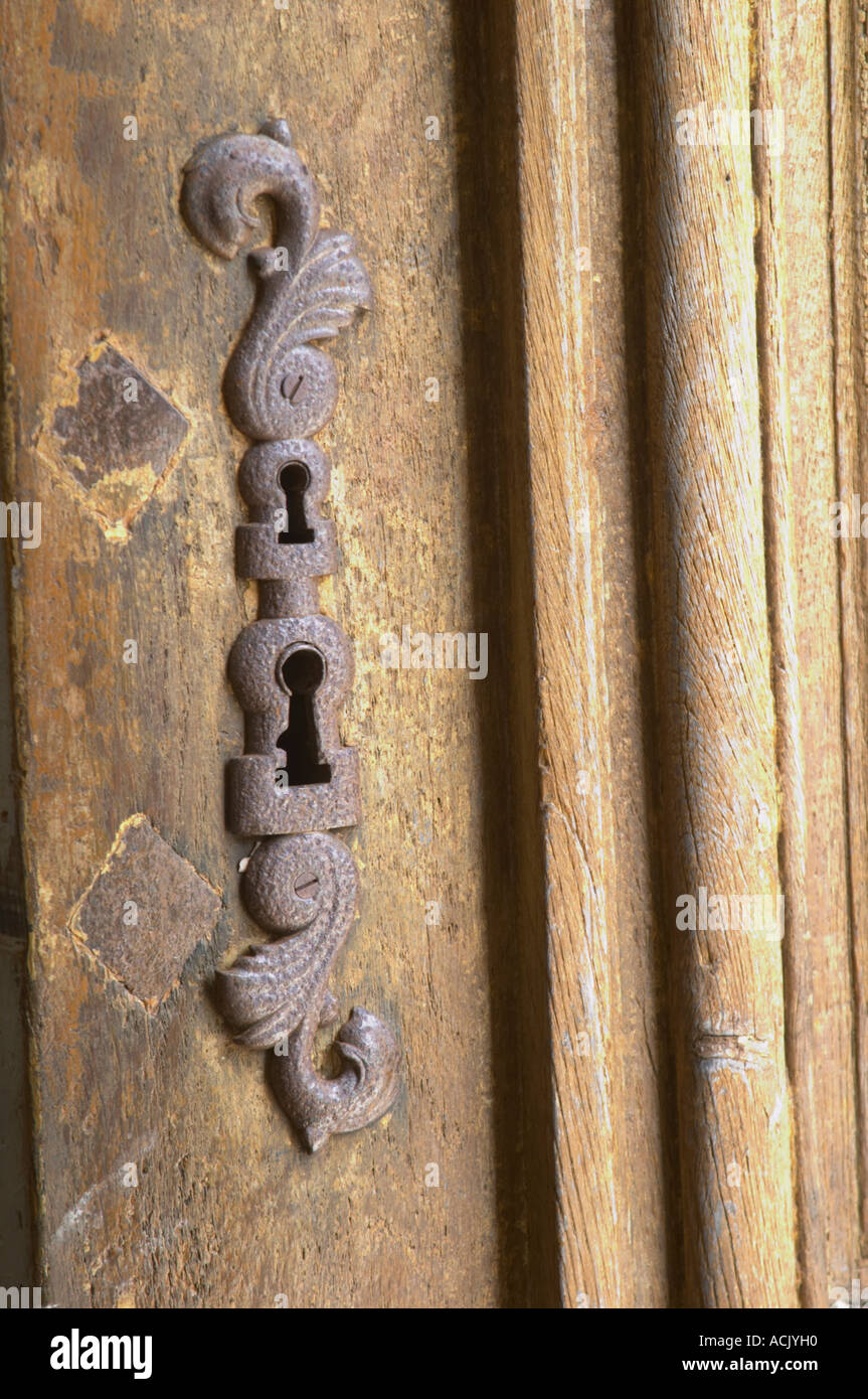 In the stately entrance hall: a key hole with a metal protection pad on an old wooden door Chateau de Cerons (Cérons) Sauternes Stock Photo