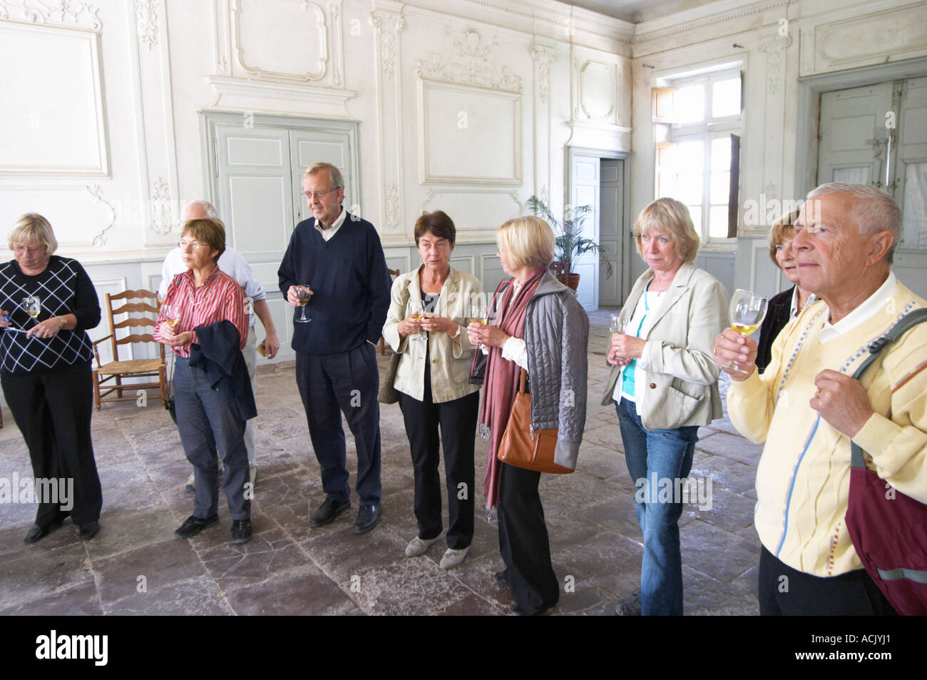 Visitors enjoying the Aperitif served in the entrance hall, a glass golden yellow of Chateau de Cerons  Chateau de Cerons (Cérons) Sauternes Gironde Aquitaine France Stock Photo