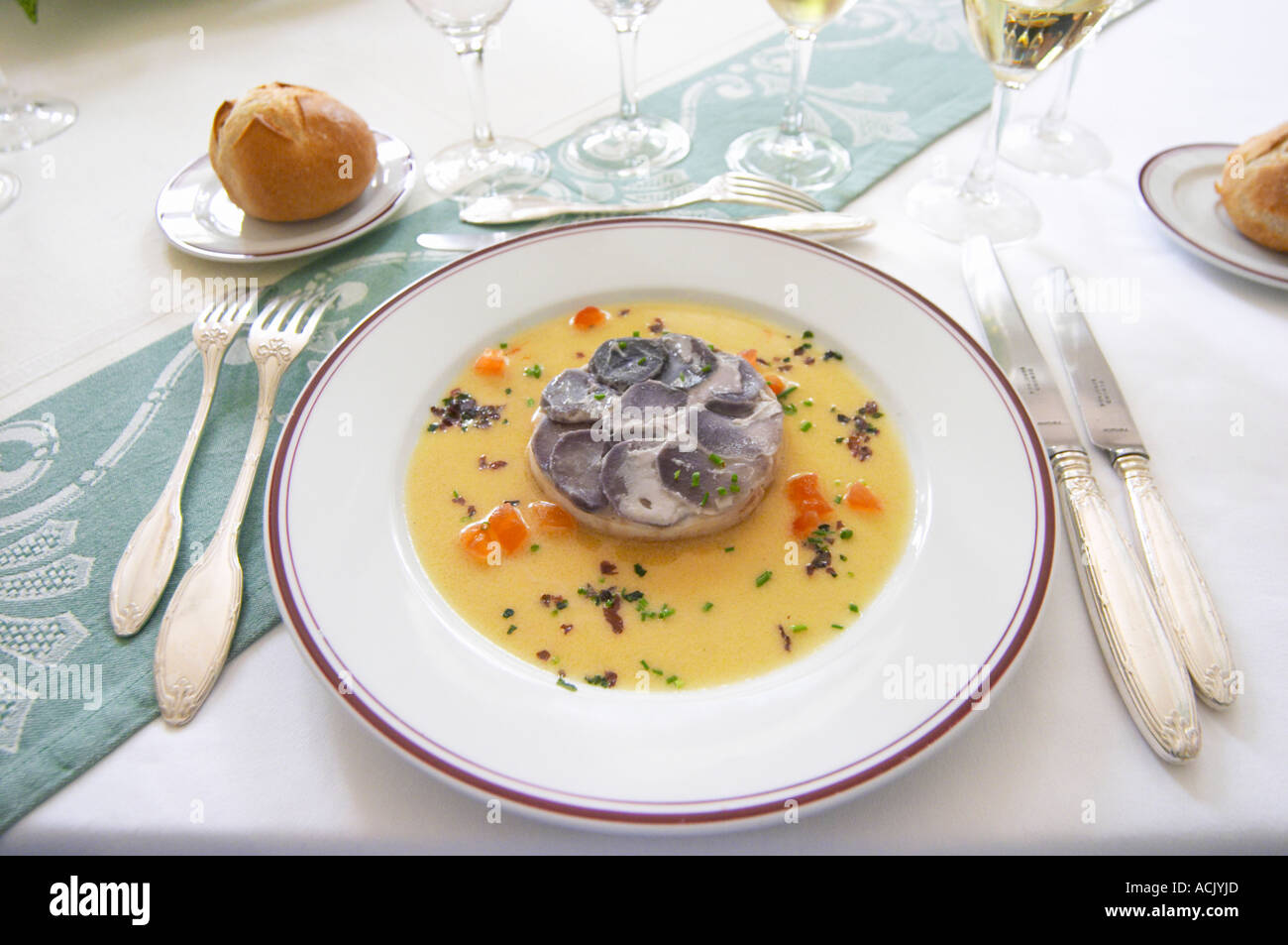 Round timbal with pikeperch fish covered with 'scales' of blue coloured potatoes in thin slices served with a beurre blanc butter sauce Chateau de Cerons (Cérons) Sauternes Gironde Aquitaine France Stock Photo