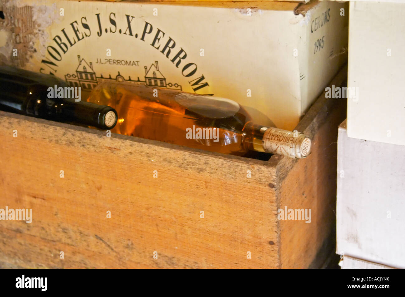 Sauternes wine bottles in a wooden crate and a carton case on top. Chateau de Cerons (Cérons) Sauternes Gironde Aquitaine France Stock Photo
