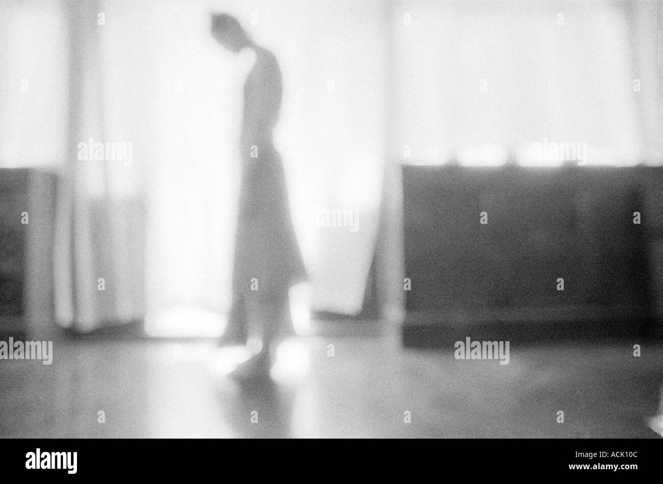 A woman standing in a bright doorway Stock Photo - Alamy