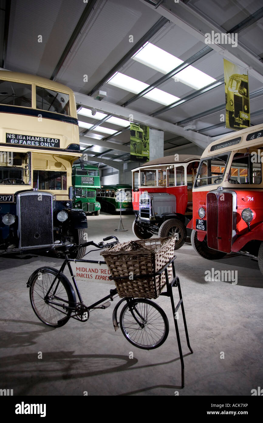 Interior of Wythall transport museum showing historic buses and parcels delivery bicycle, UK Stock Photo