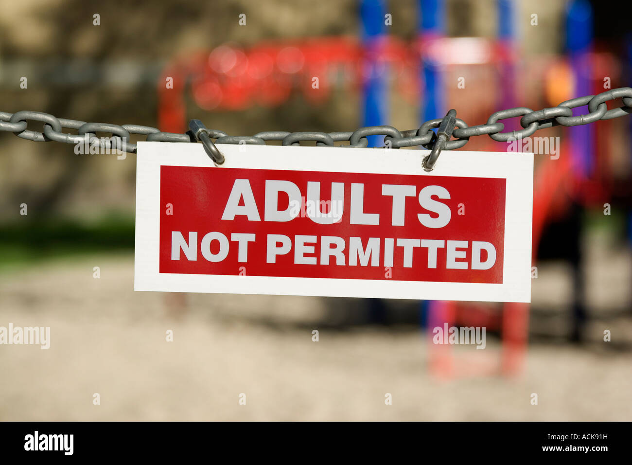 Adults Not Permitted sign with playground in background Stock Photo