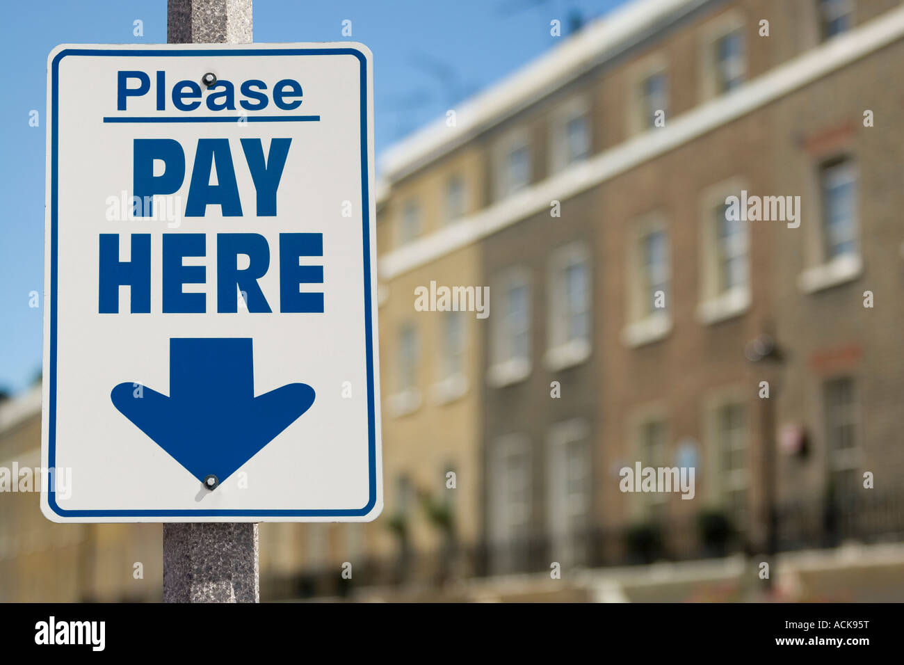 Please Pay Here sign with arrow pointing down Stock Photo