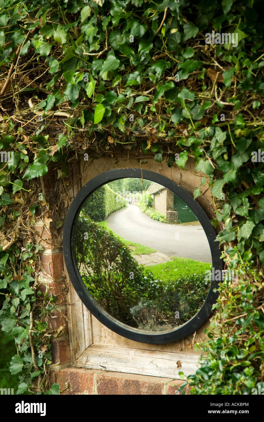 roadside convex mirror on entrance to see on coming traffic Stock Photo