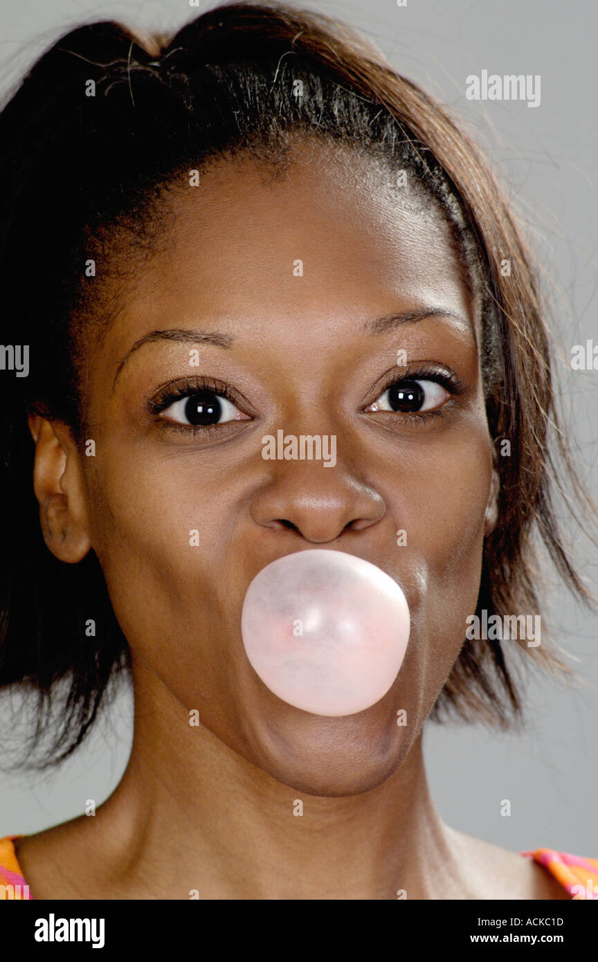 Woman blowing a bubble gum Stock Photo