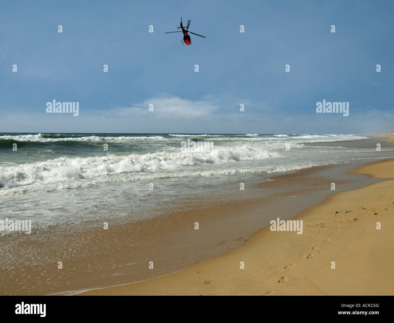 Atlantic of coast guard flying over the beach Stock Photo - Alamy