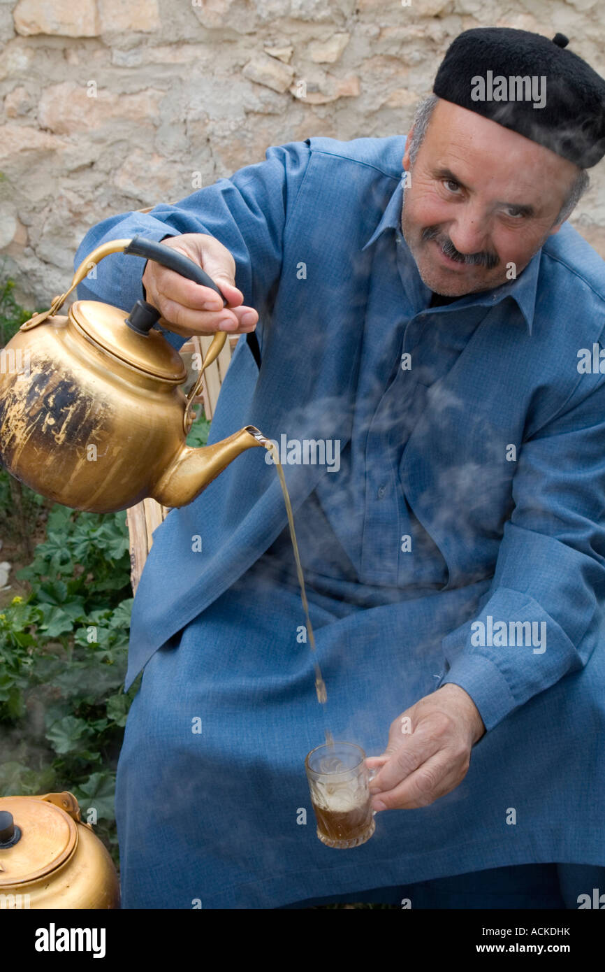 Kabaw, Libya. Libyan Pouring Tea Wearing Tunisian Chechia (Hat Stock