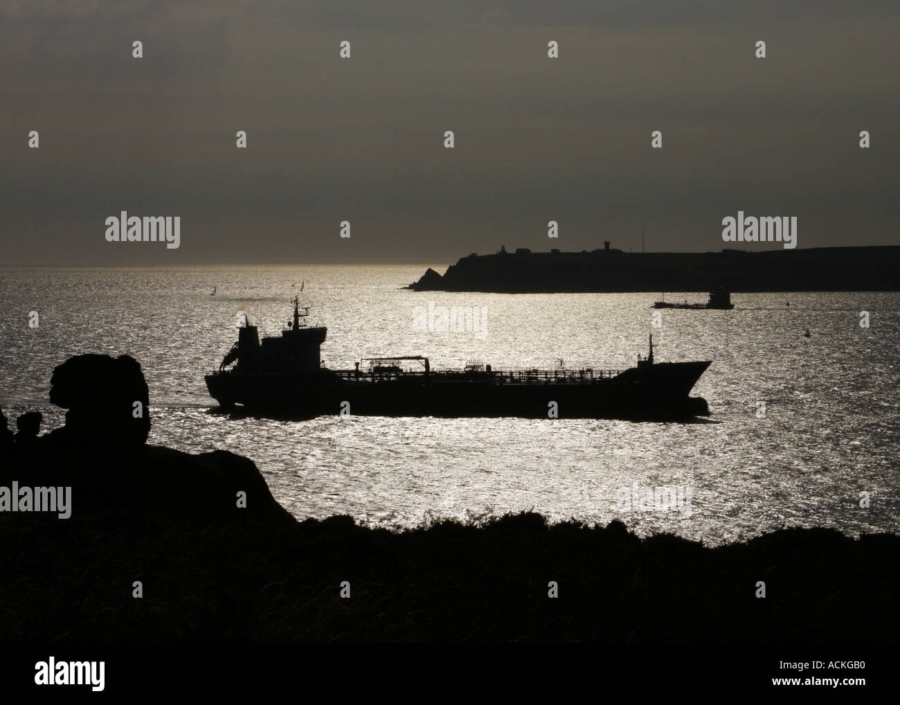 Silhouette of Oil Tanker entering Milford Haven. Stock Photo