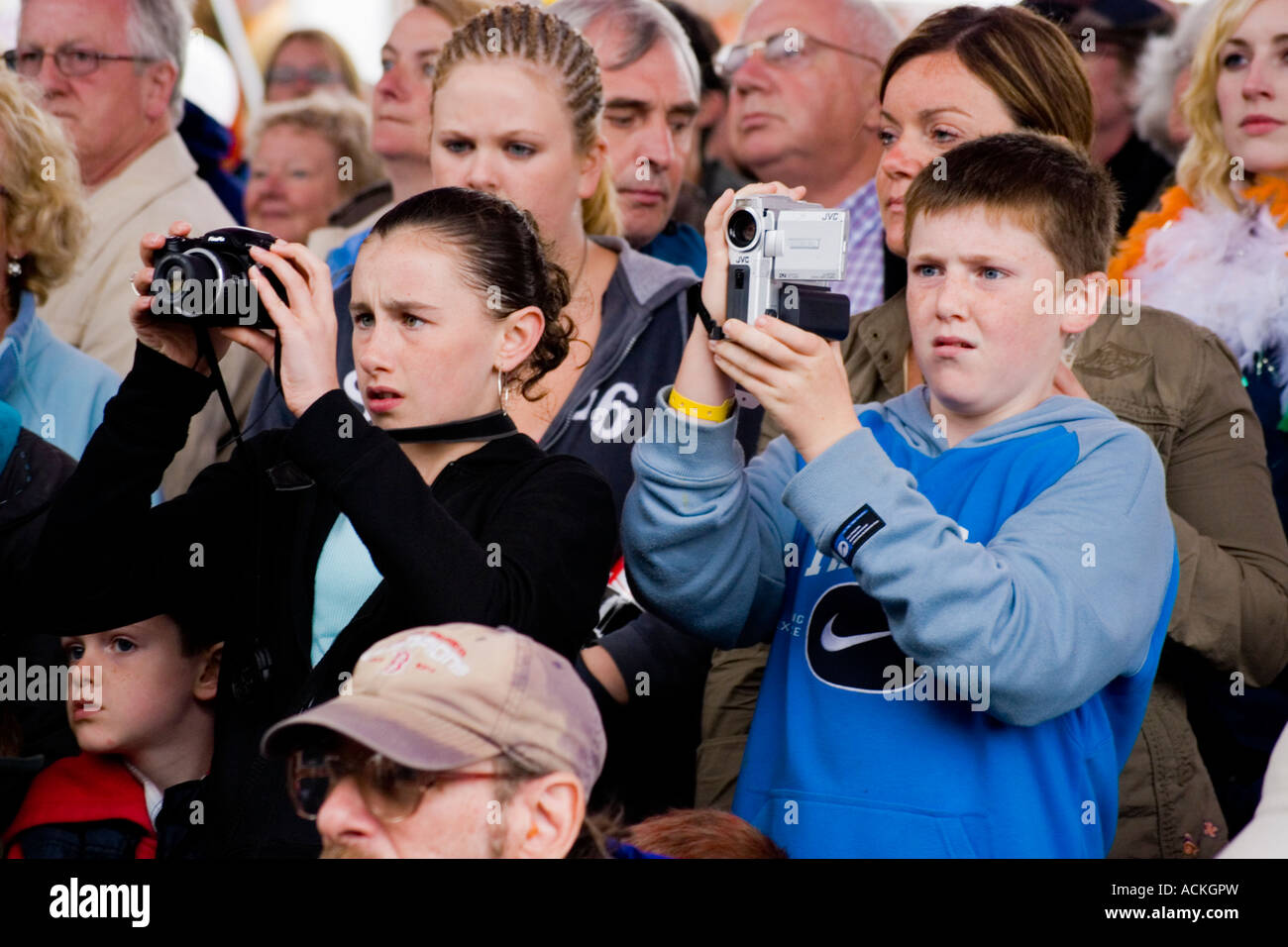 Boy and girl videoing and photographing live music concert, Ireland Stock Photo