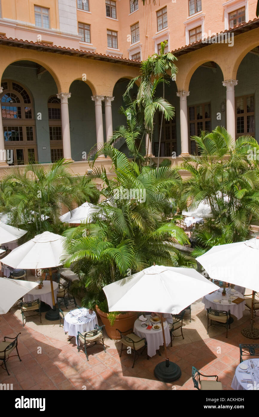 Outdoor courtyard restaurant with umbrellas providing shade to the dining tables Stock Photo