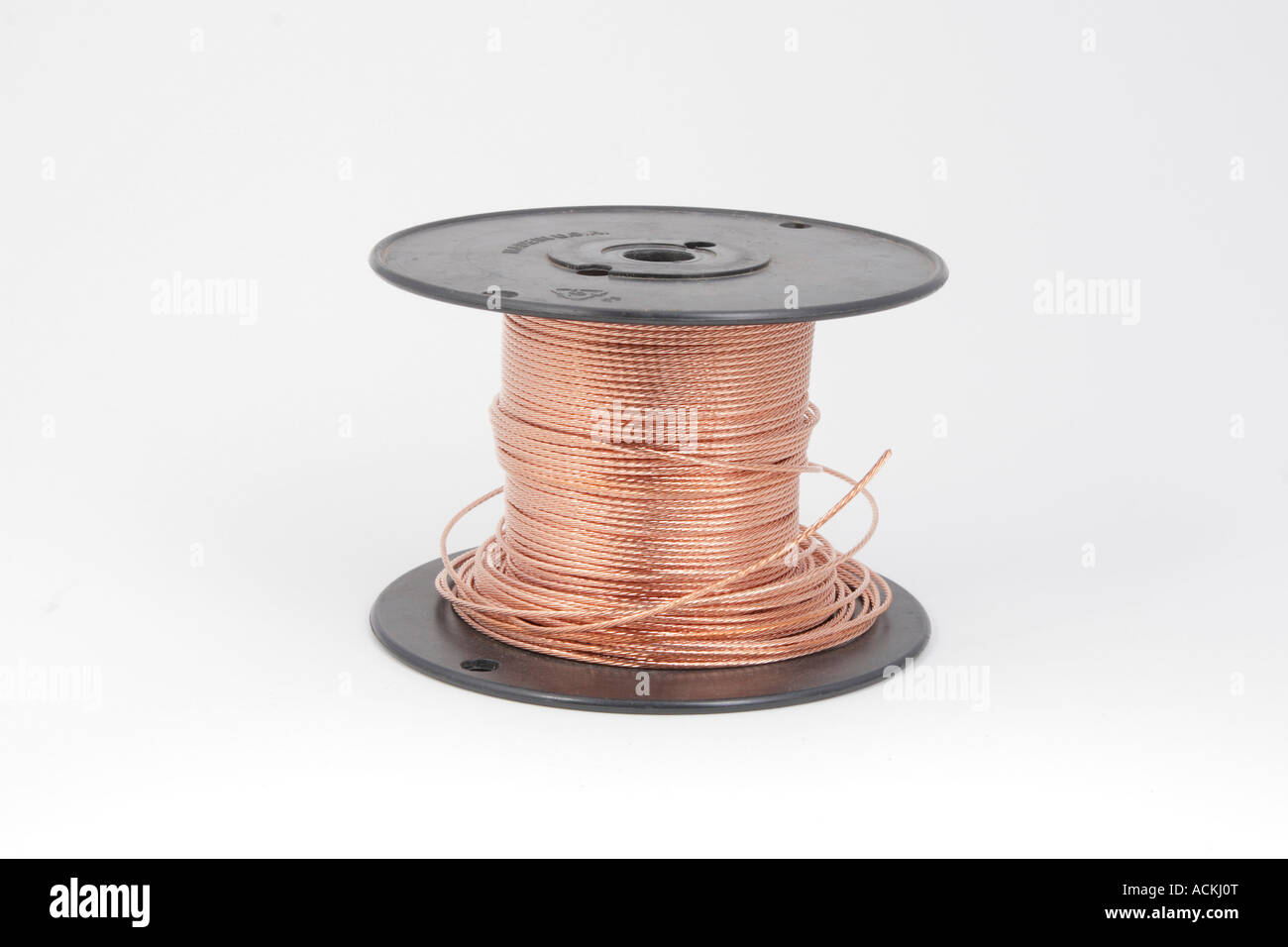 Spool of stranded copper wire on black plastic wire reel Stock Photo