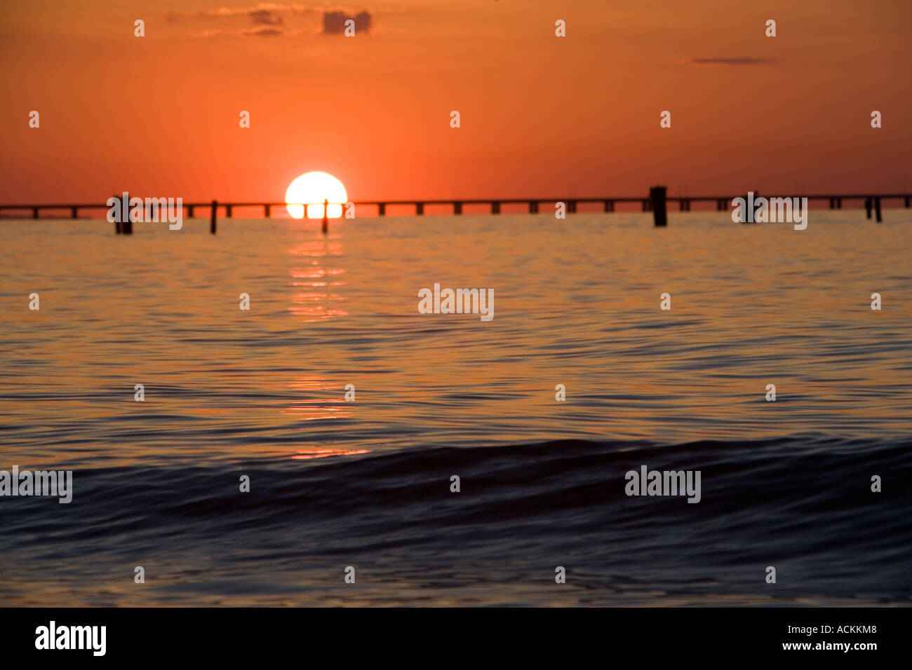 Sunset at Lynnhaven Inlet Virginia Beach VA Chesapeake Bay Bridge Tunnel in background Stock Photo