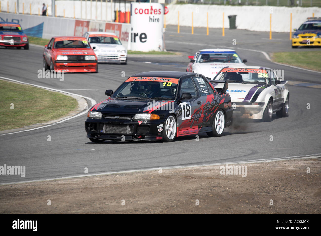 modified Mitsubishi EVO III race car leads the pack into a corner at a