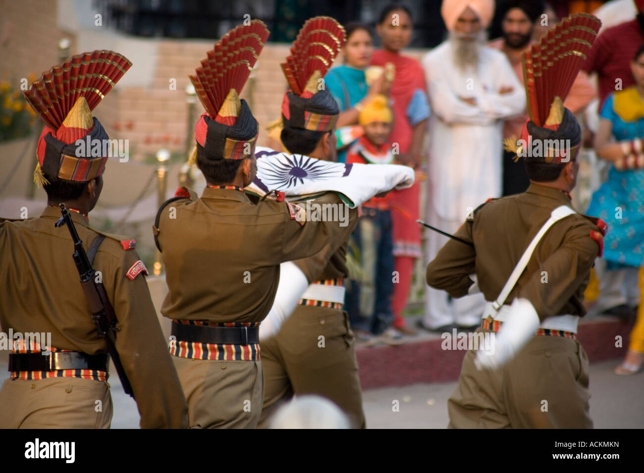 Folded Indian flag being marched off to bed by Indian border guards Stock Photo