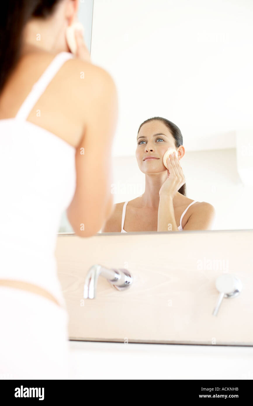 Lady Using Powder A young woman applying powder on her face Stock Photo - Alamy