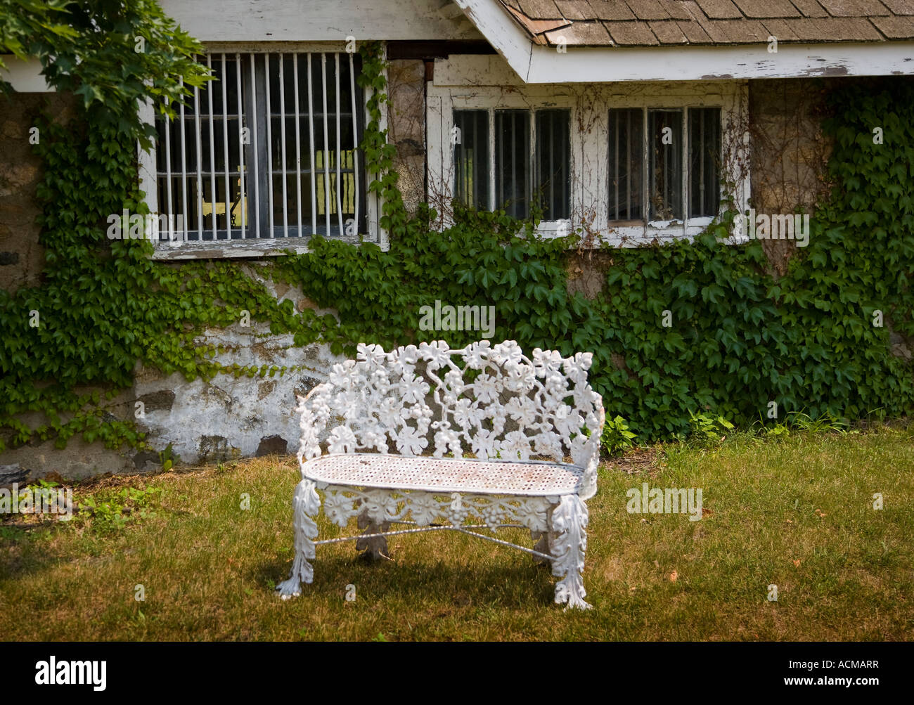 Ornate bench in front of a rustic building Stock Photo - Alamy