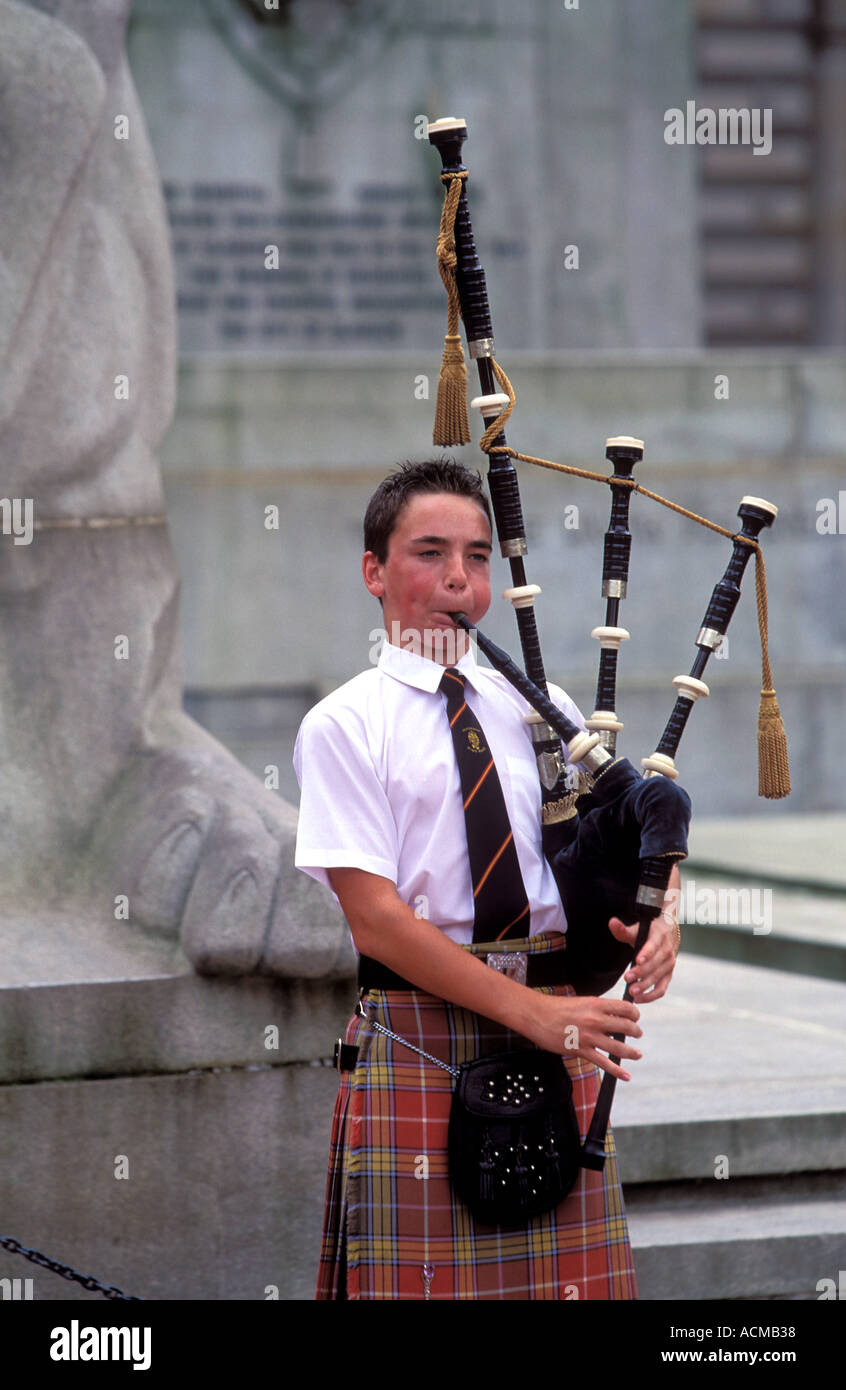 Scotland Glasgow Kid playing a traditional bagpipe at Glasgow s Town hall George Square Stock Photo