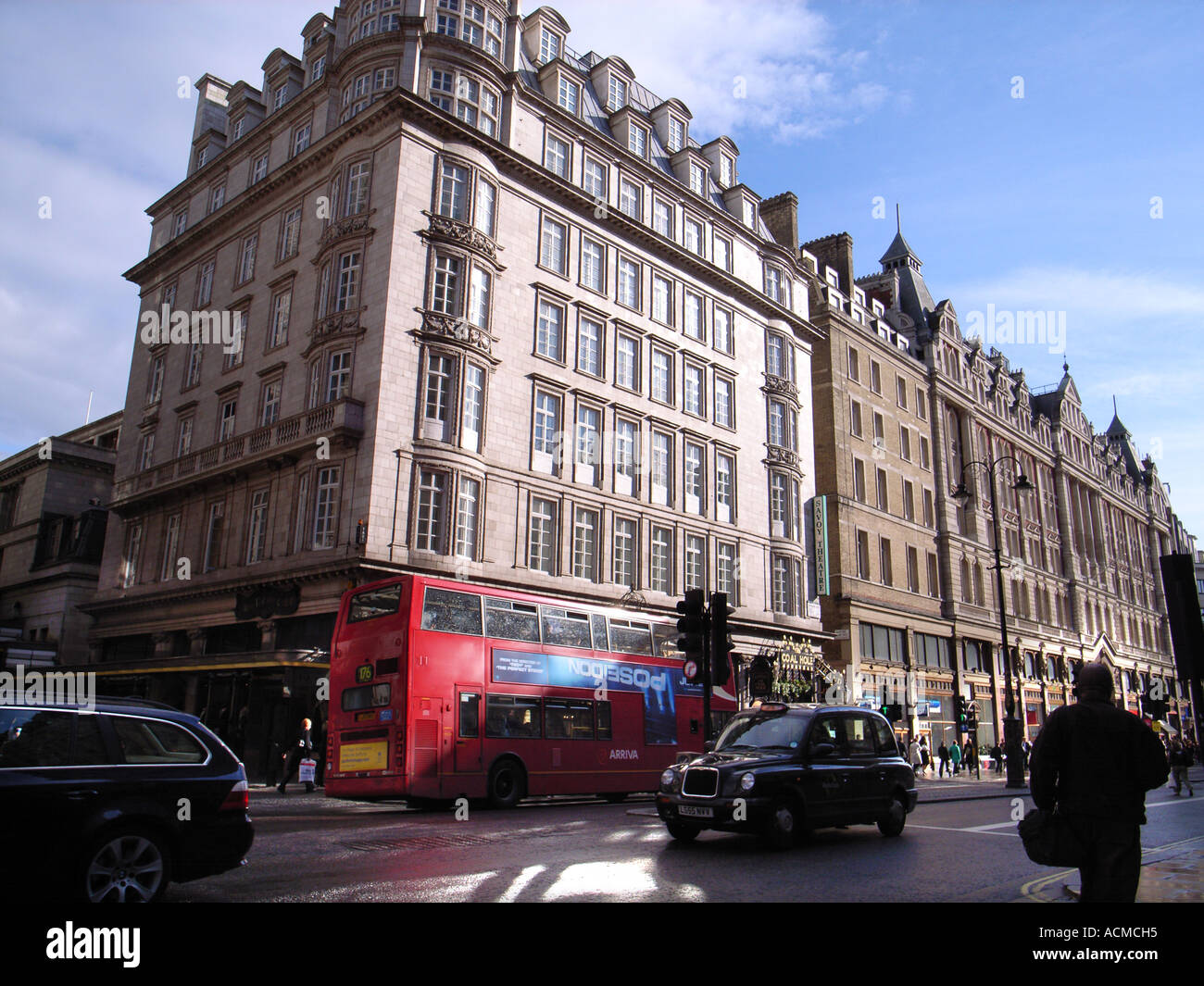 The Strand with red buses London UK Stock Photo