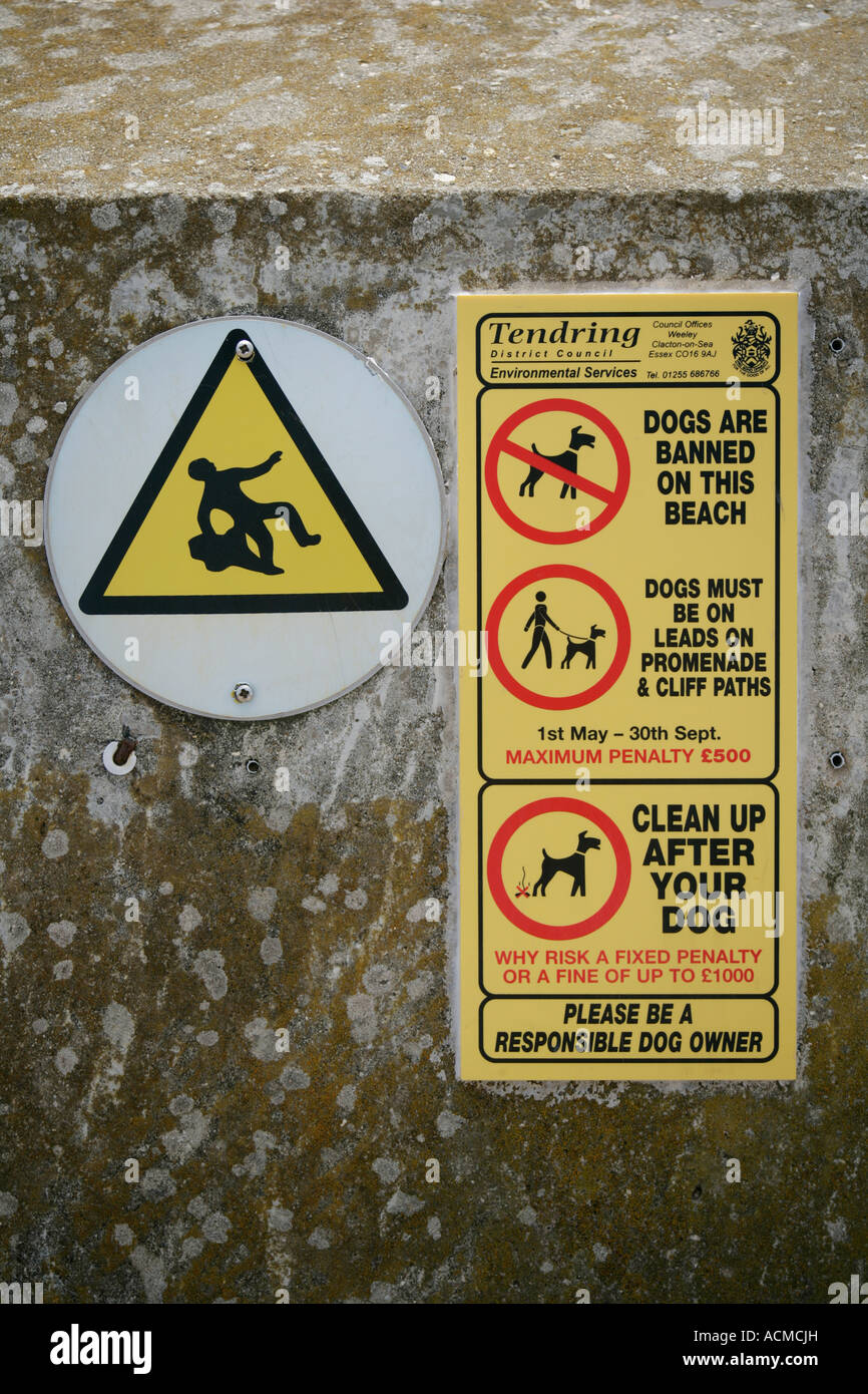 Tendring District Council warning notices to dog owners affixed to sea wall, Frinton on Sea Essex England UK Stock Photo