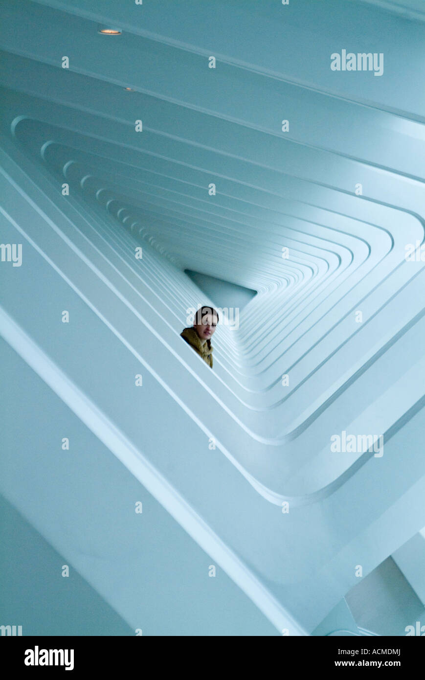 A FEMALE LOOKING OUT OF THE REPEATED TRIANGULAR WINDOWS Stock Photo - Alamy