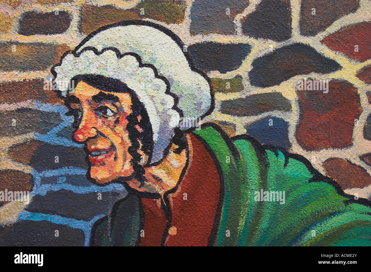 A mural of a fisherwoman on the side of a shop in Main Guard