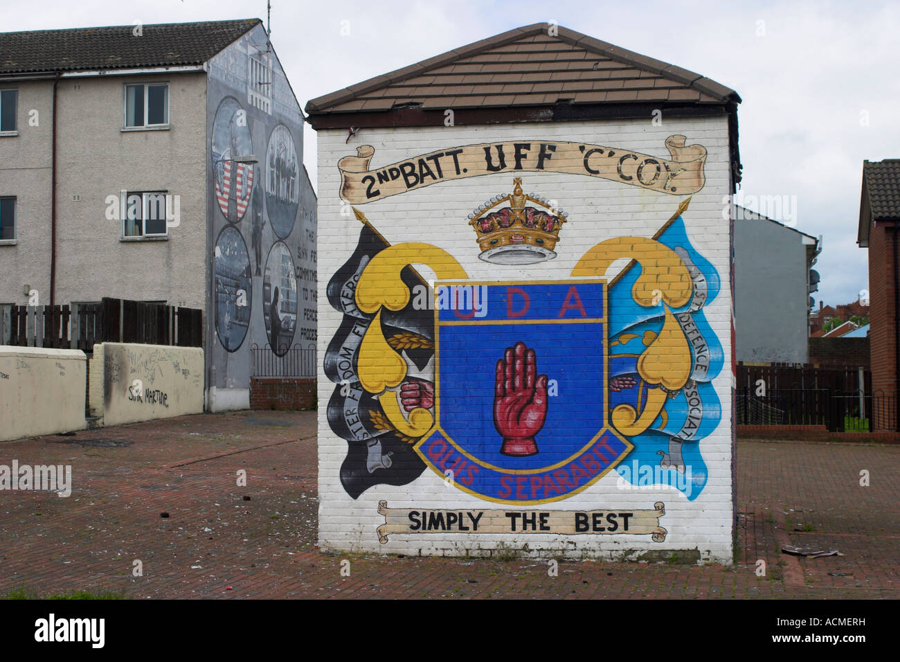 Mural with UDA emblem and UDA and UFF flags  Shankill Road Belfast County Antrim Northern Ireland Stock Photo