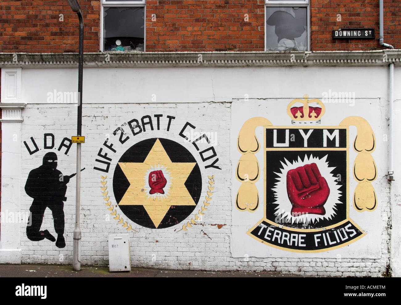 UFF and UYM emblems and a silhouette of UDA commando Mural on Downing Street off Shankill Road Belfast Stock Photo