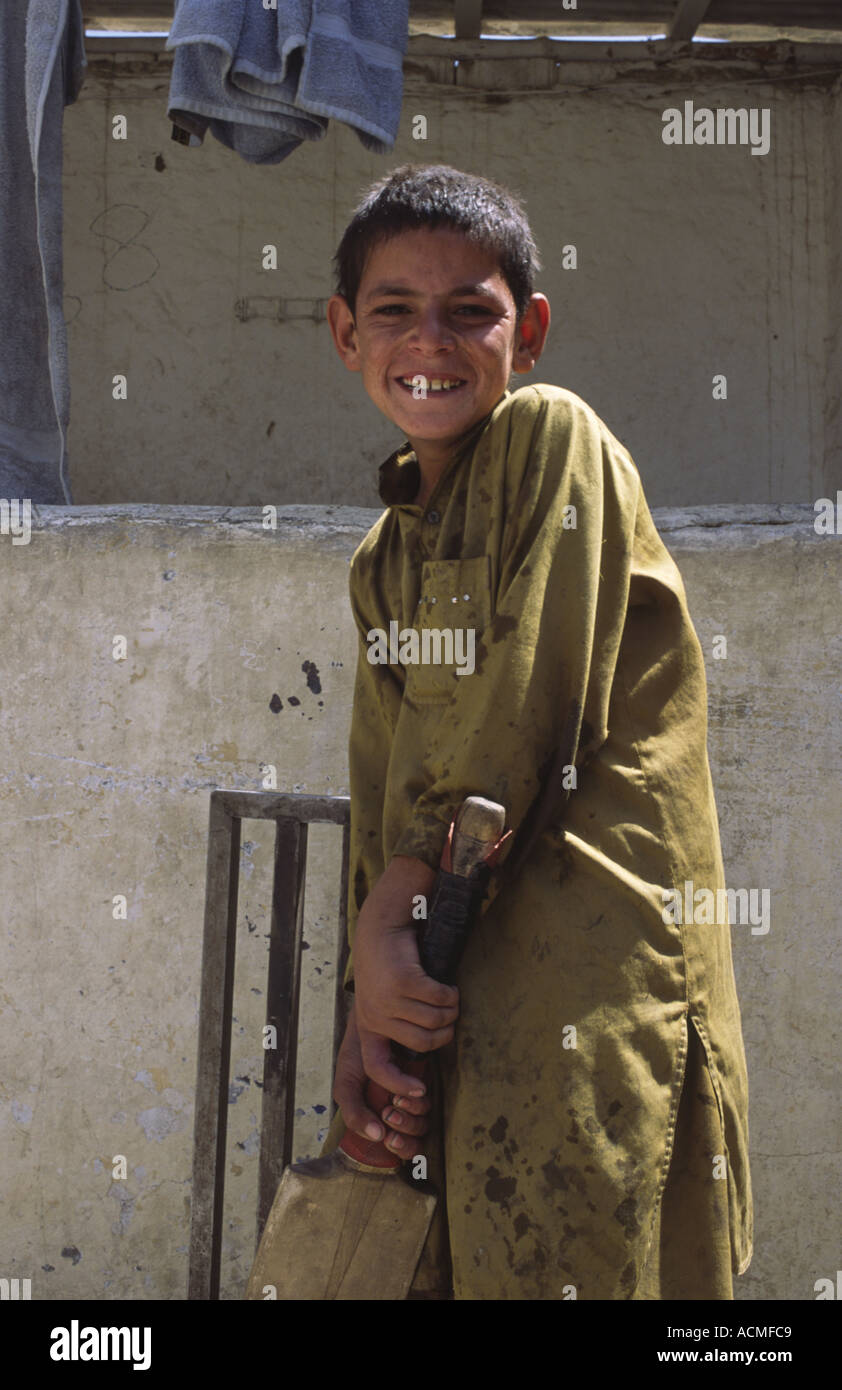 Young Afghan refugee playing cricket at an NGO funded drop in centre in Quetta Balochistan Pakistan Stock Photo