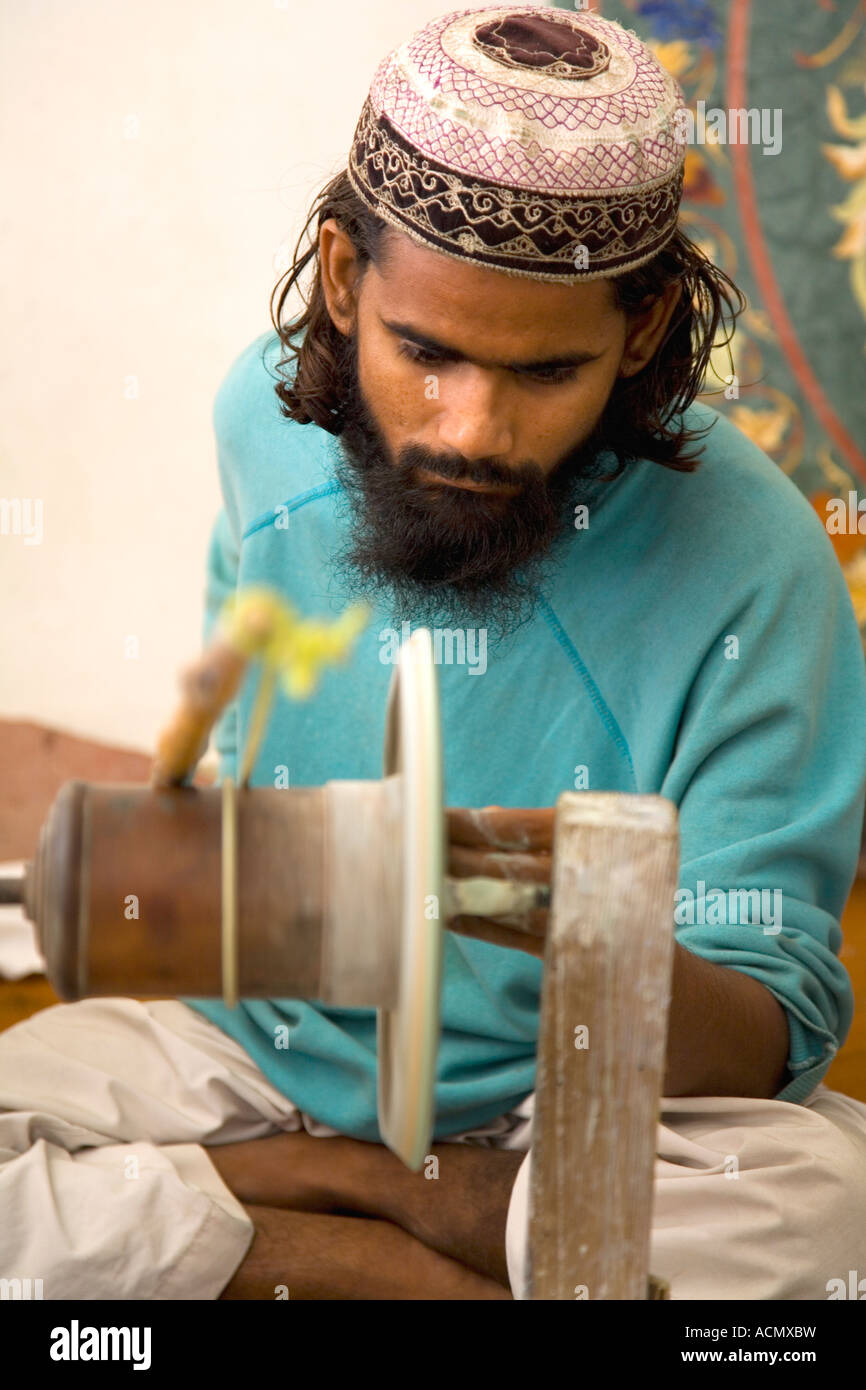 Agra craftsman grinds semi-precious stones for use in inlaid marble goods Uttar Pradesh India Stock Photo