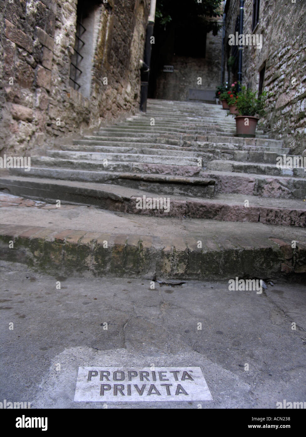 Proprieta Privata Private Property sign inlaid in stone at foot of worn staircase Assisi Italy Stock Photo