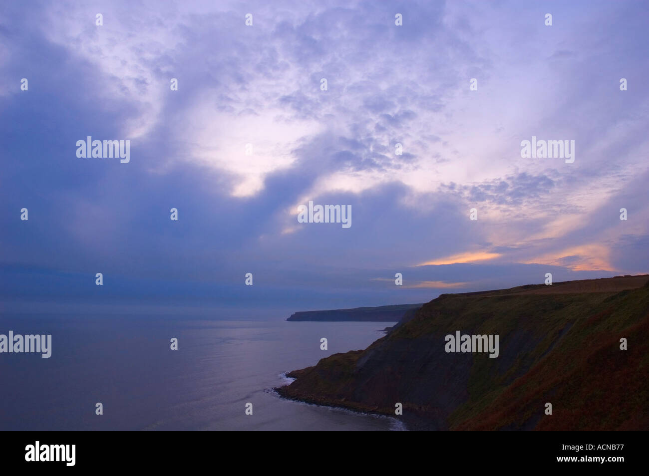 sunrise over cliffs at Port Mulgrave North Yorkshire England United Kingdom Stock Photo