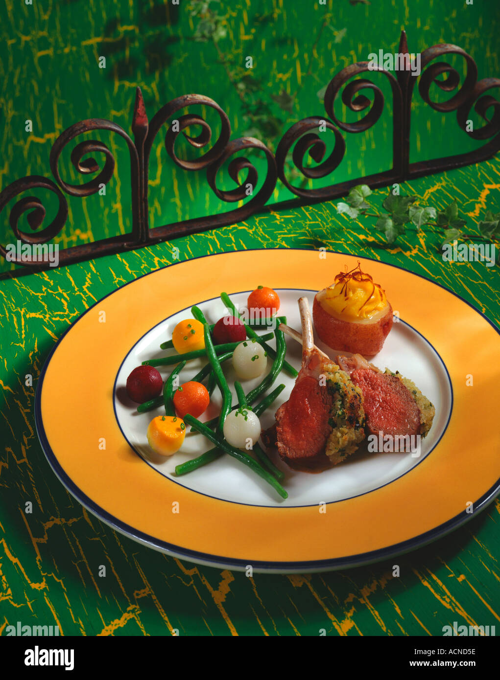 Rack of lamb served with hand carved vegetable plate of carrots. red